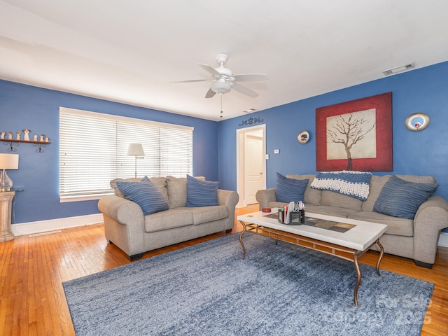 living room featuring hardwood / wood-style flooring and ceiling fan