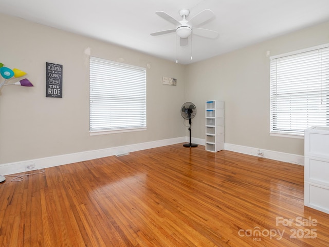 unfurnished room with ceiling fan and light wood-type flooring