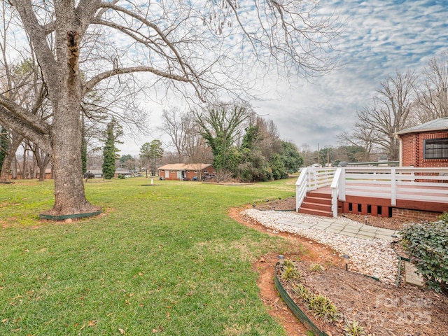 view of yard featuring a wooden deck