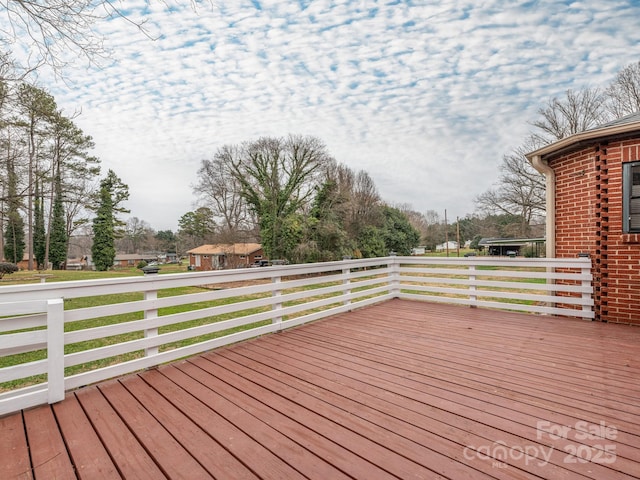 wooden terrace featuring a yard