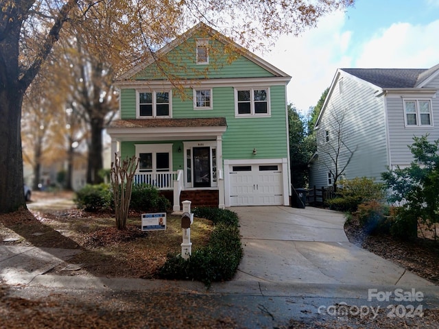 view of front of home featuring covered porch and a garage