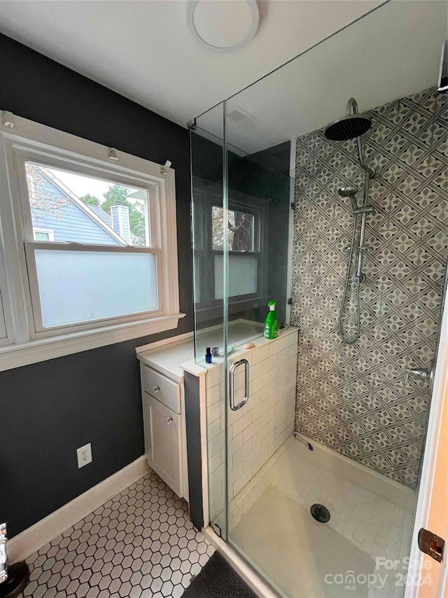 bathroom featuring tile patterned floors and a shower with shower door