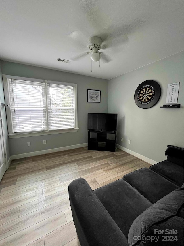 living room with ceiling fan and light hardwood / wood-style floors