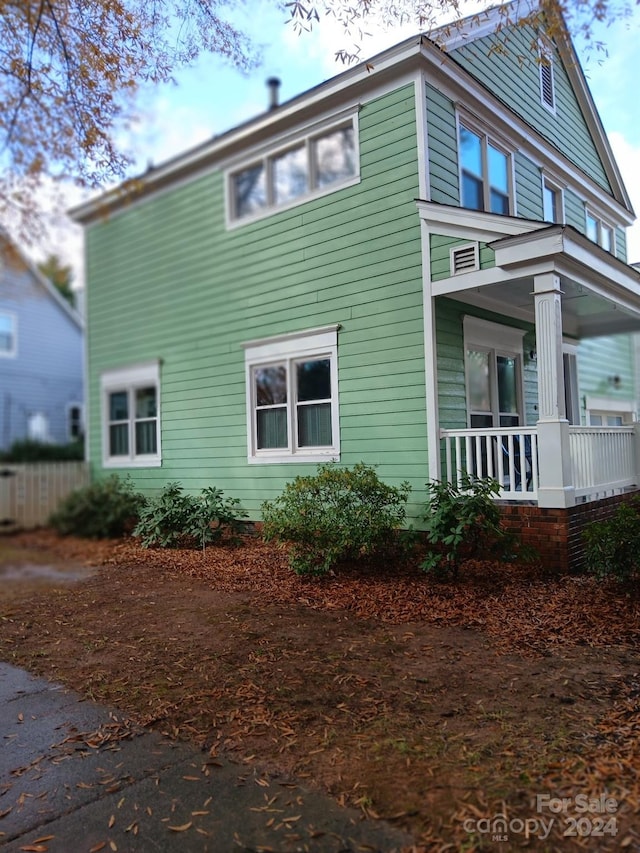 view of side of property with covered porch