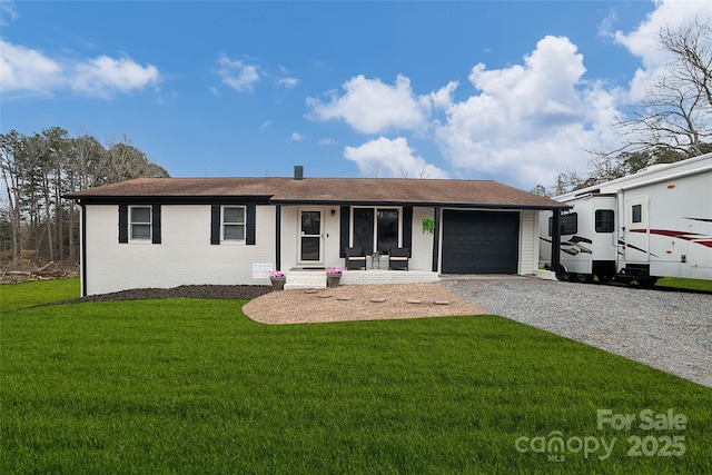 ranch-style home with a garage, a front lawn, and a porch