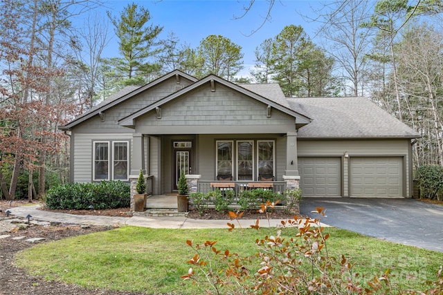 craftsman-style home with a front yard, a porch, and a garage