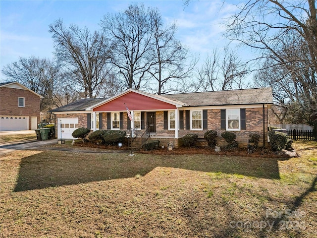 single story home featuring a front lawn, covered porch, and a garage