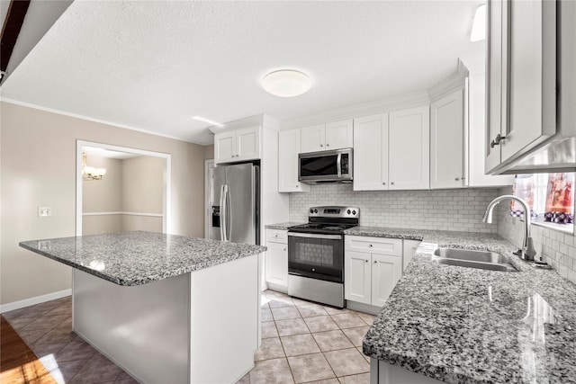 kitchen with sink, a center island, white cabinets, and appliances with stainless steel finishes