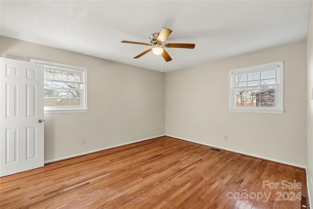 spare room featuring ceiling fan and light hardwood / wood-style flooring