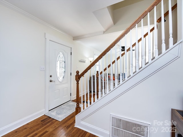 foyer entrance featuring crown molding and hardwood / wood-style floors