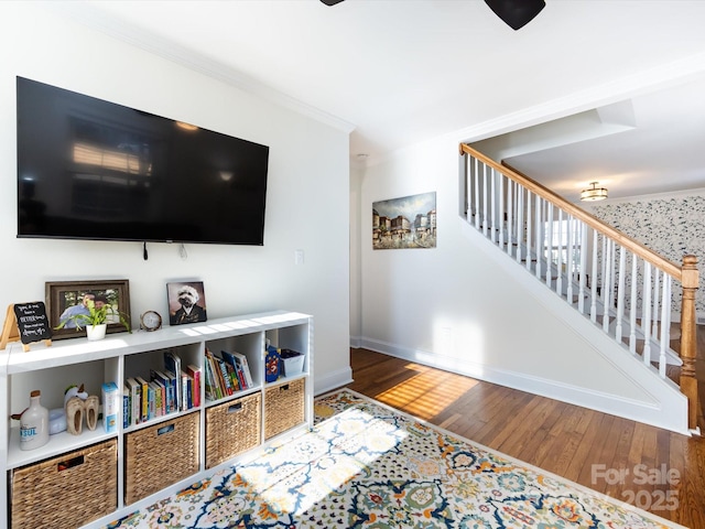 living room with hardwood / wood-style flooring and crown molding