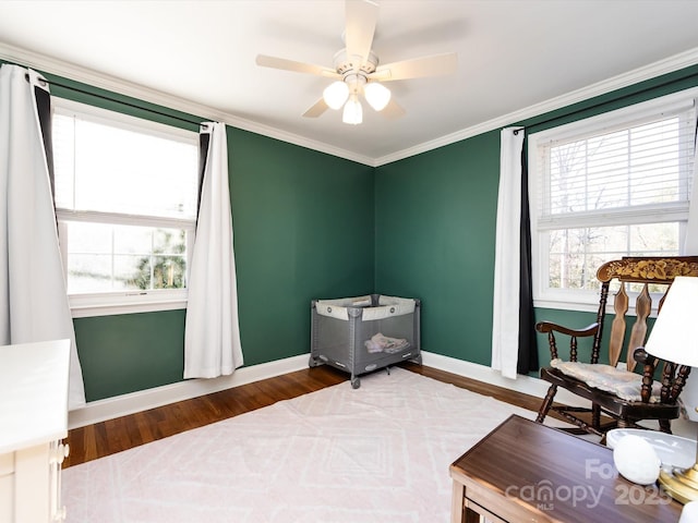 interior space featuring crown molding, wood-type flooring, and ceiling fan