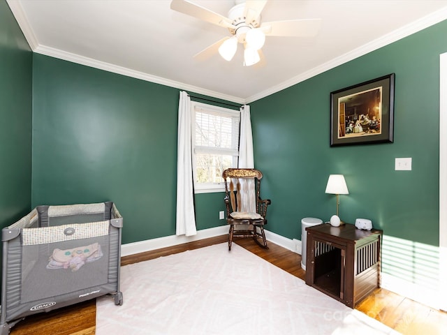 bedroom with hardwood / wood-style flooring, crown molding, and ceiling fan