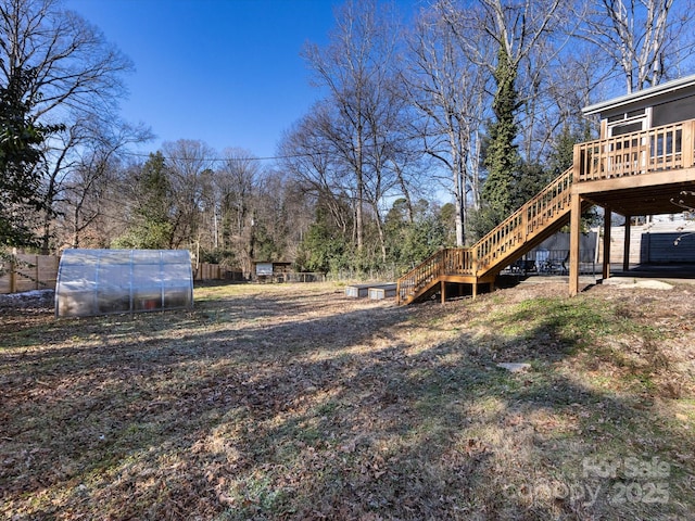 view of yard featuring an outdoor structure and a deck