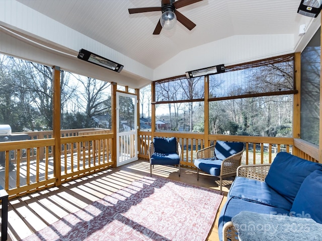 sunroom featuring ceiling fan and vaulted ceiling