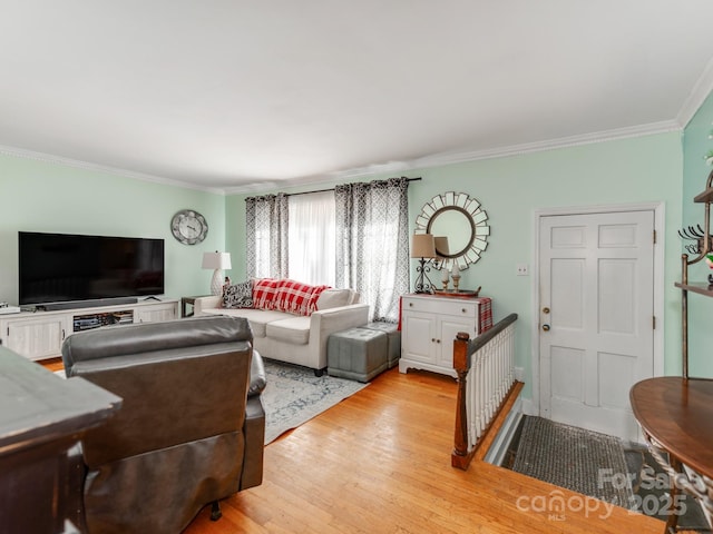 living room with crown molding and light hardwood / wood-style floors