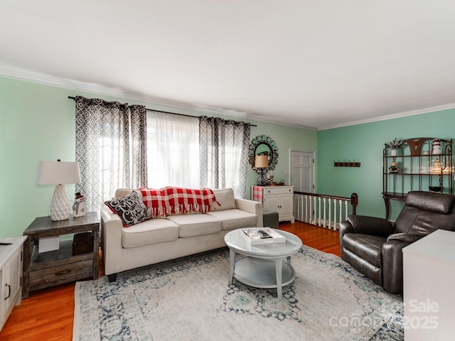 living room with hardwood / wood-style flooring and ornamental molding