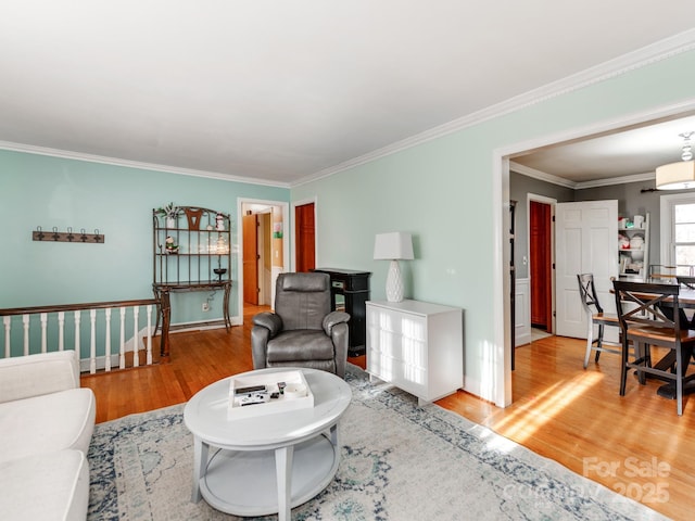 living room with wood-type flooring and ornamental molding