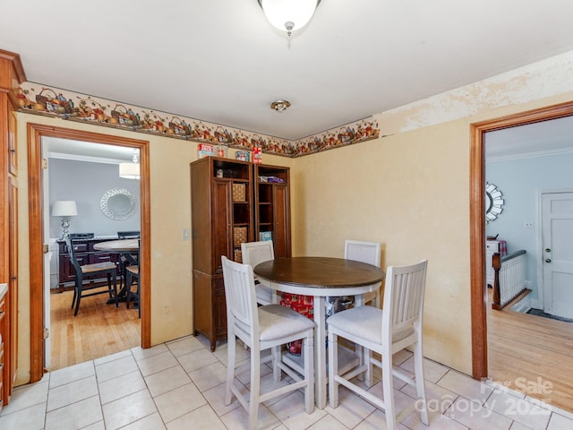 tiled dining space with ornamental molding