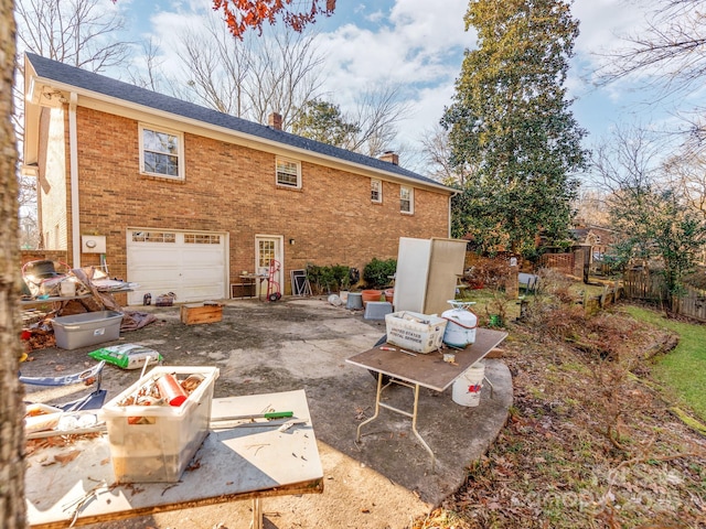 back of house with a garage