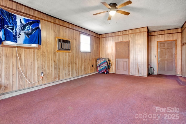 carpeted spare room featuring ceiling fan, an AC wall unit, and a textured ceiling