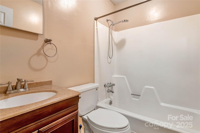 full bathroom with vanity, toilet, and  shower combination