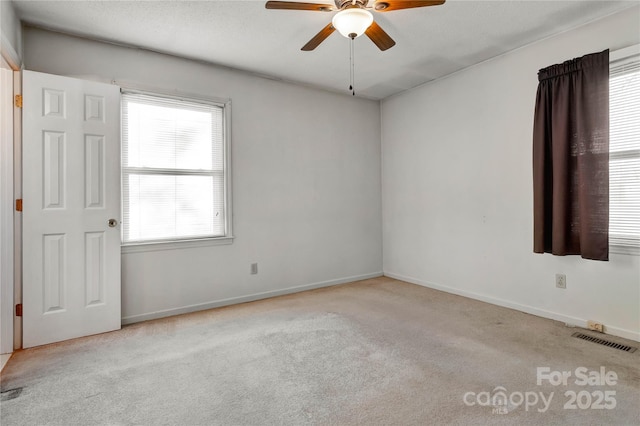 empty room with light carpet and ceiling fan