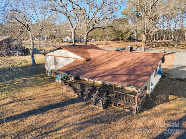 view of side of home with a yard