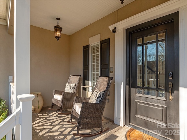 view of exterior entry with a porch