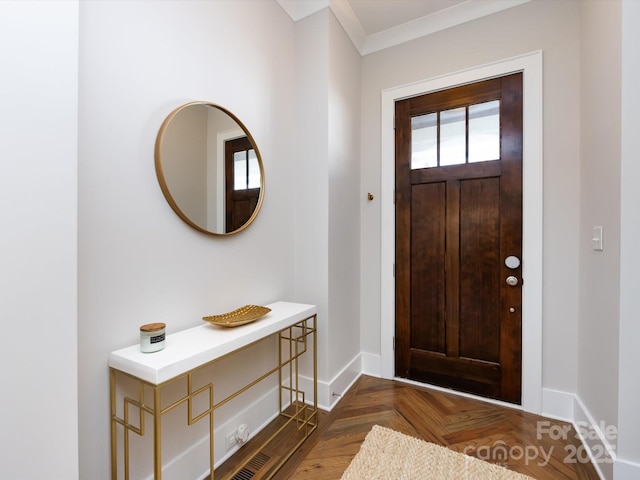 entryway featuring ornamental molding and baseboards