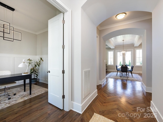 hall with arched walkways, parquet flooring, visible vents, ornamental molding, and beamed ceiling