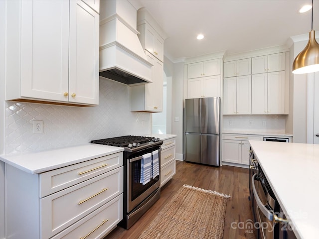 kitchen featuring premium range hood, dark wood-type flooring, white cabinets, light countertops, and appliances with stainless steel finishes