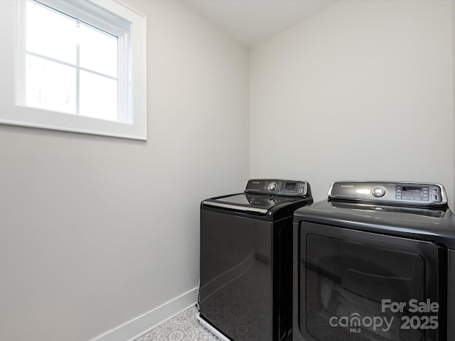 laundry room featuring laundry area, washing machine and dryer, and baseboards