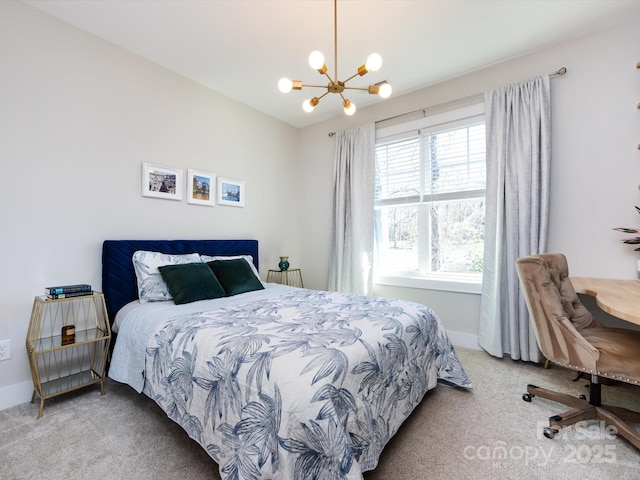 bedroom with a chandelier, carpet floors, and baseboards