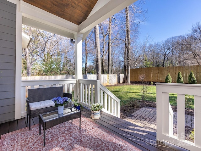 deck featuring a yard and a fenced backyard