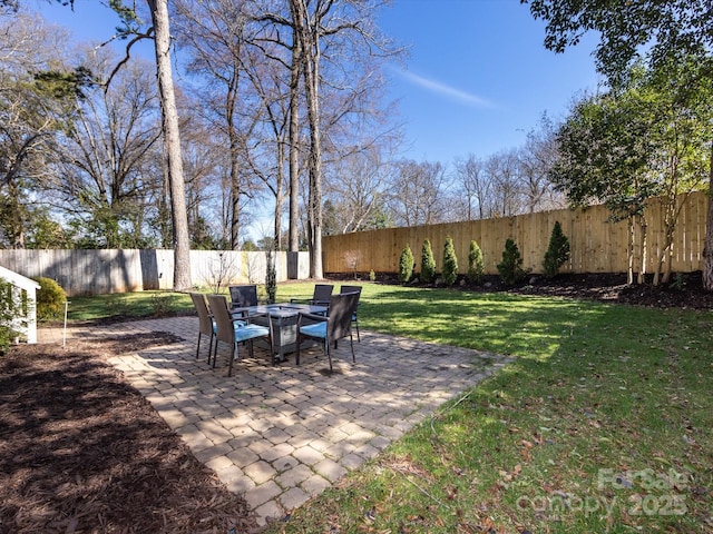 view of yard featuring an outdoor fire pit, a fenced backyard, and a patio