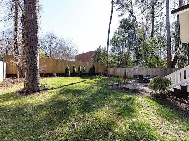 view of yard with a patio area and a fenced backyard