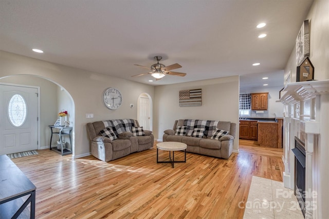 living room featuring ceiling fan and light hardwood / wood-style flooring