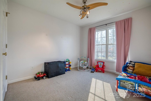 recreation room with ceiling fan and carpet