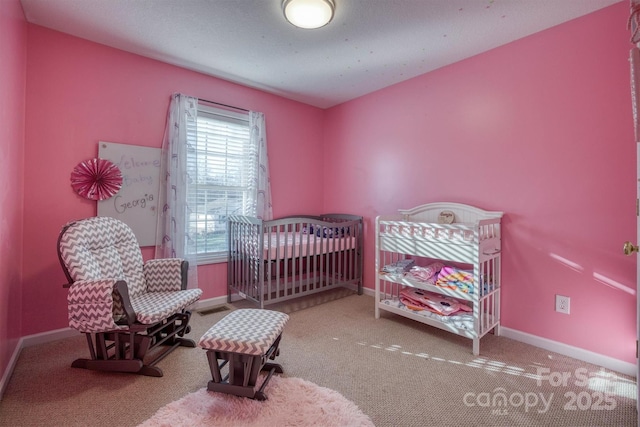 bedroom featuring carpet and a nursery area