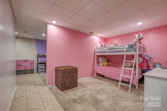 tiled bedroom featuring a paneled ceiling