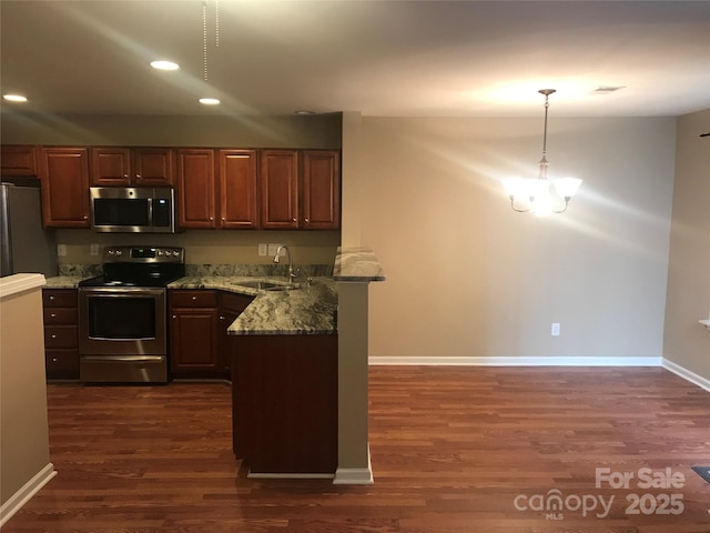 kitchen featuring light stone countertops, stainless steel appliances, dark hardwood / wood-style floors, and sink