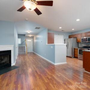 unfurnished living room featuring ceiling fan and light hardwood / wood-style flooring