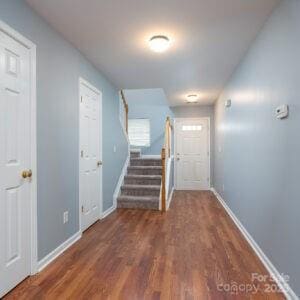 hall with dark hardwood / wood-style floors