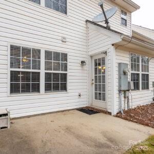 view of exterior entry with a patio