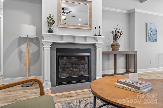 living room with crown molding, hardwood / wood-style floors, and ceiling fan