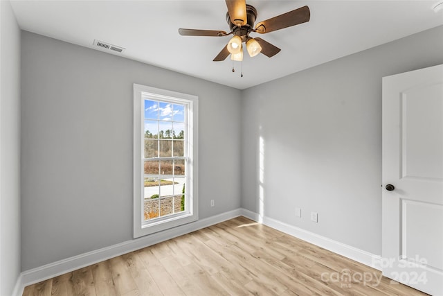 unfurnished room with light hardwood / wood-style flooring, plenty of natural light, and ceiling fan