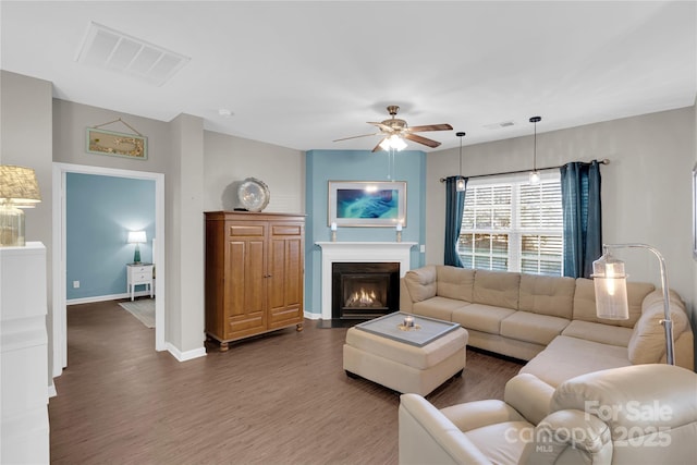 living room featuring dark hardwood / wood-style floors and ceiling fan