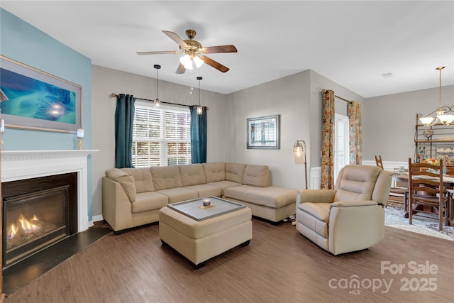 living room featuring ceiling fan and dark wood-type flooring