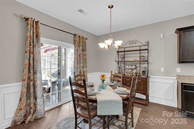 dining area featuring dark hardwood / wood-style floors and a notable chandelier